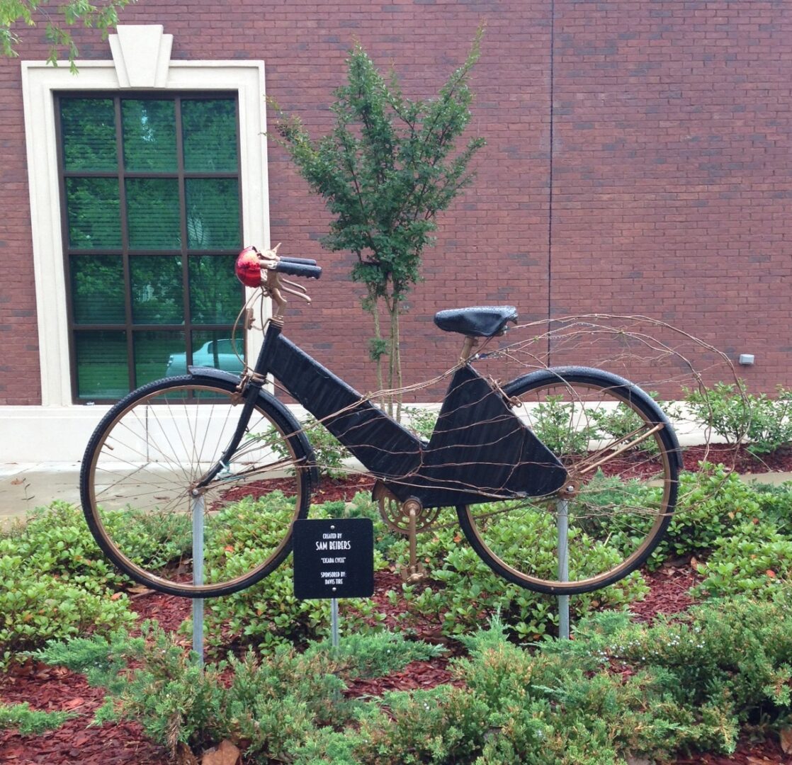 A bicycle statue in front of a building.